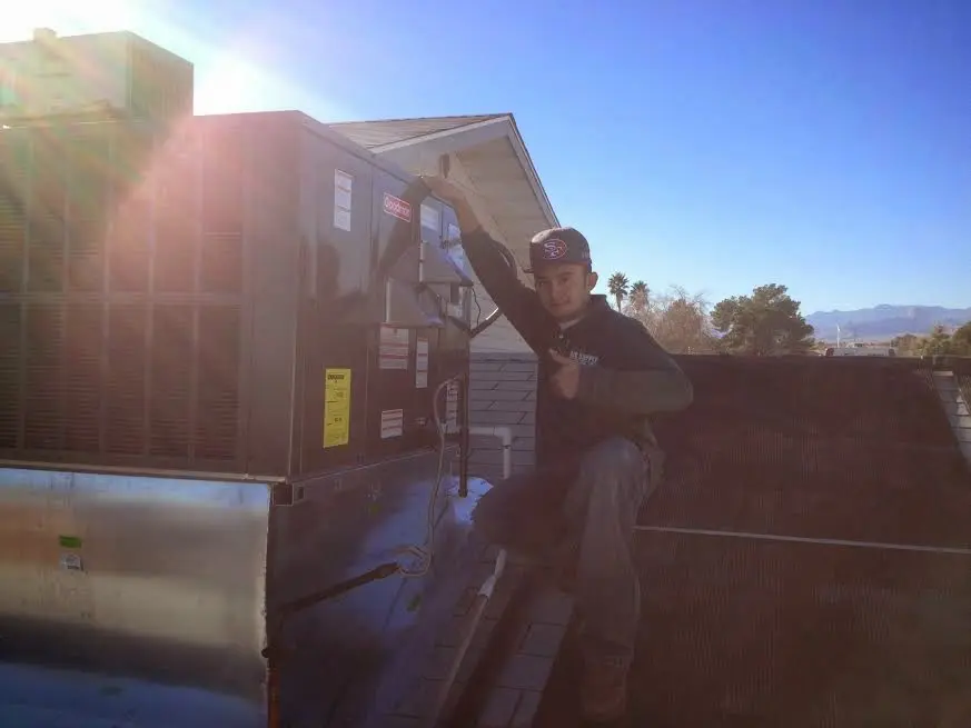 HVAC technician performing Boiler Repair on a rooftop unit in Kingsland